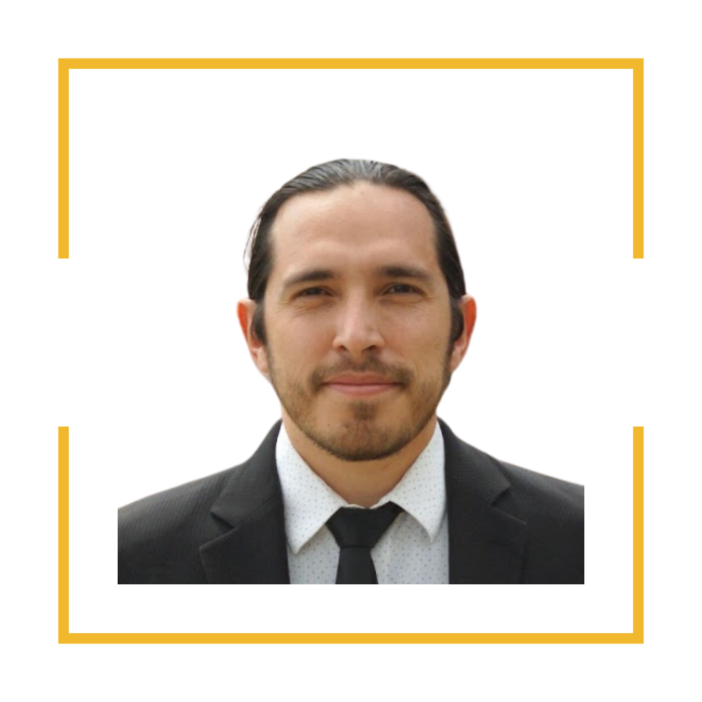 Image of student assistant, John K. Bonilla. He is wearing a white dress shirt with a black tie and black suit jacket.