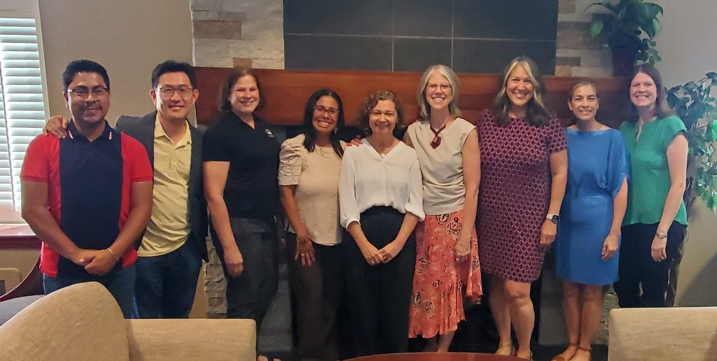 Photo of 9 individuals from Dr. Corinne Valdivia's retirement celebration.